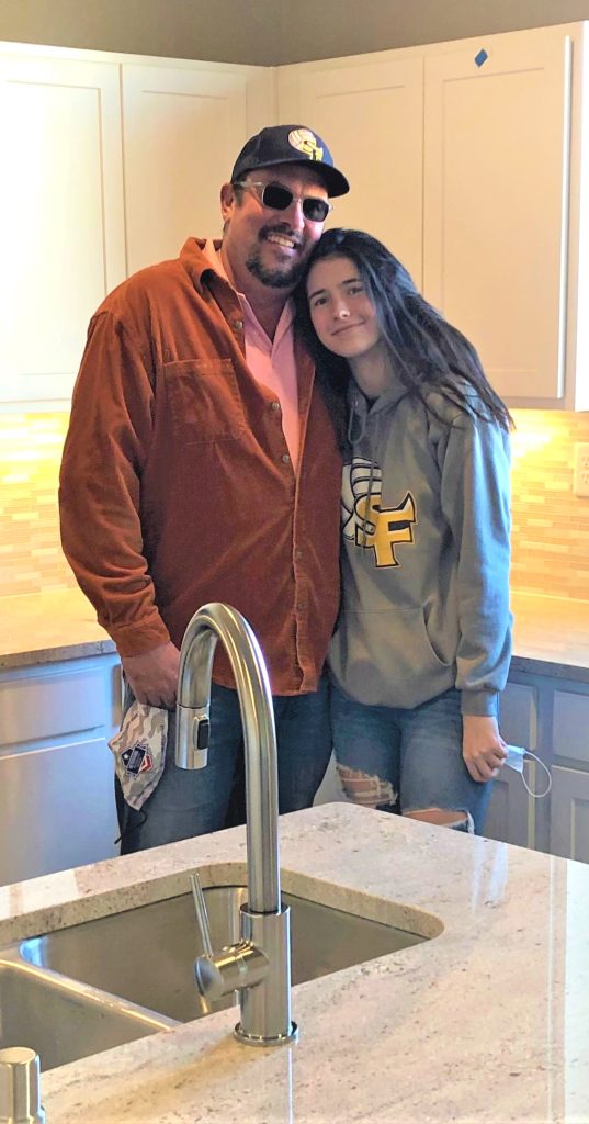 Happy family standing in their new kitchen in Santa Fe New Mexico.