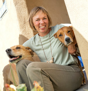 Erin with her dogs at her home that HomeWise helper her purchase.